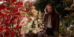A man stands in a garden.