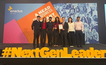 Group of students on stage at the Enactus UK & Ireland World Cup Qualifier at Expo ExCeL London on 7 to 8 April 2025, standing behind large yellow 3D letters spelling #NextGenLeader