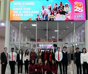 Group of students standing below a sign with large text – Welcome to Enactus UK & Ireland Expo 2025