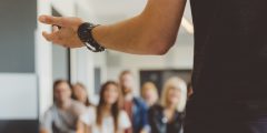 Man presenting in front of an audience