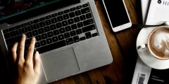 Person Sitting Facing Laptop Computer With Sketch Pad