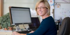Woman sitting at a desk smiling