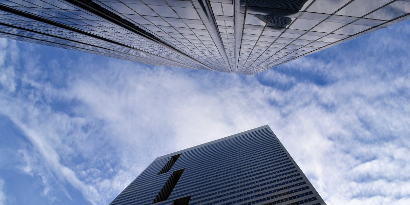 Looking up at two skyscrapers