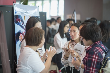 Students discussing with employers