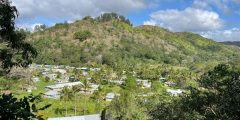 A distant view of a villagei in a valley in Fiji