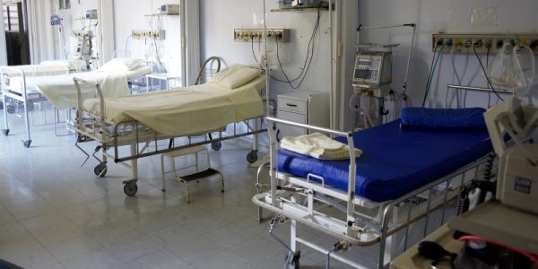 A hospital ward with several empty beds