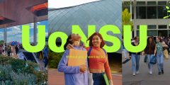 Two students standing in front of a sign: UoN SU