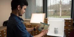 Photo of a student using an iPad and Structure Scanner