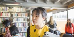 Student walking through Djanogly Learning Resource Centre