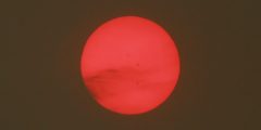 Red sun as seen through smoke after wildfire