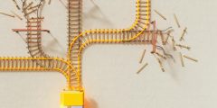 An artist’s illustration of artificial intelligence (AI). This image depicts AI safety research to prevent its misuse and encourage beneficial uses. There four branching railway lines three of which fizzle out in match sticks lying in disarray