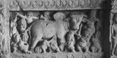 Plate showing an intricate stone carving of people and a bull.