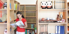 Female undergraduate student reading in a library, Si Yuan Building, Jubilee Campus